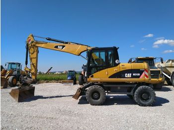 Escavatore gommato CAT M313D *Oilquick OQ65