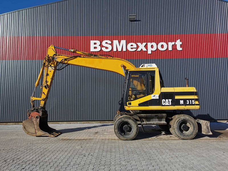 Caterpillar M315 wheel excavator - Escavatore gommato: foto 1 Caterpillar M315 wheel excavator - Escavatore gommato: foto 1