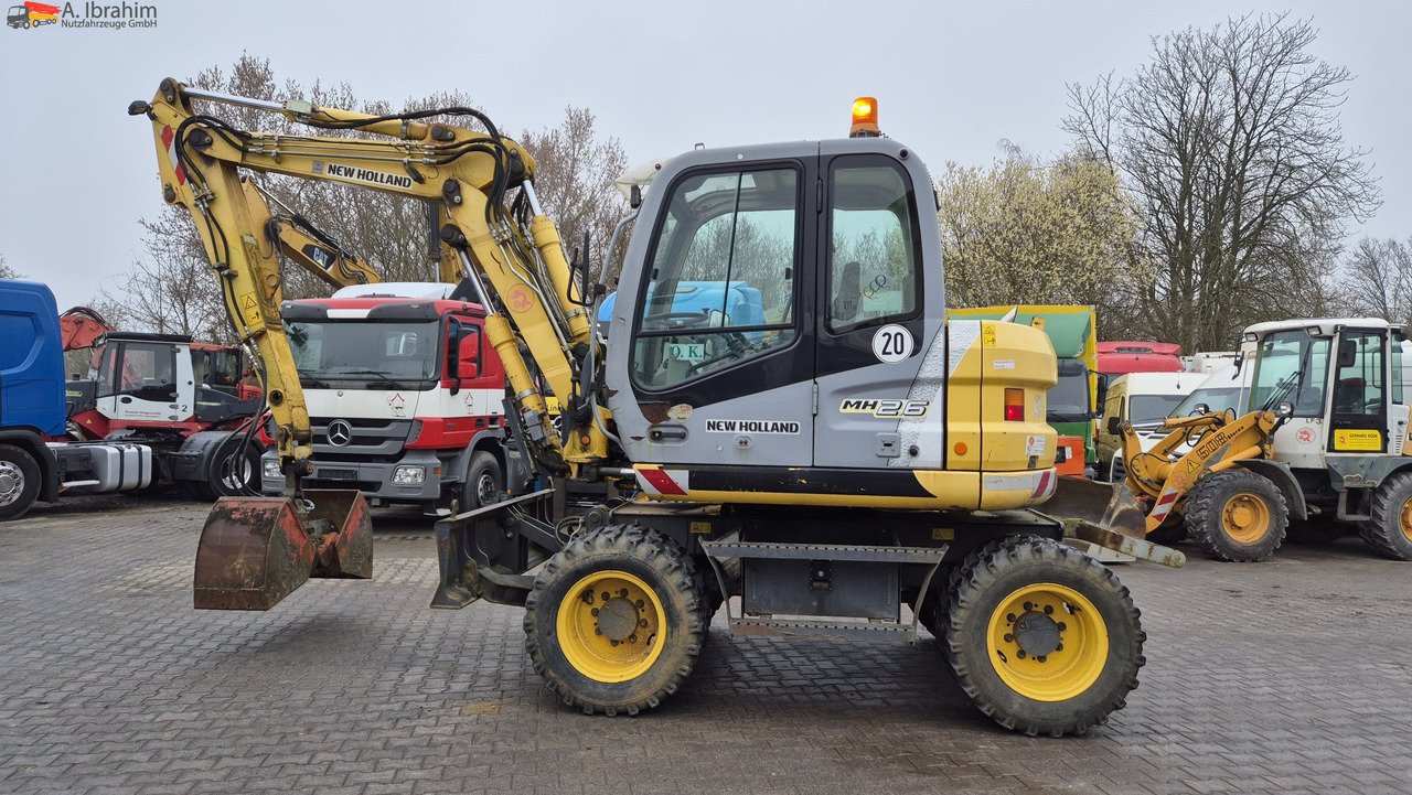 New Holland MH 2.6 Zustand gut, deutsche Maschine incl. Greifer und Dreservo - Escavatore gommato: foto 1 New Holland MH 2.6 Zustand gut, deutsche Maschine incl. Greifer und Dreservo - Escavatore gommato: foto 1