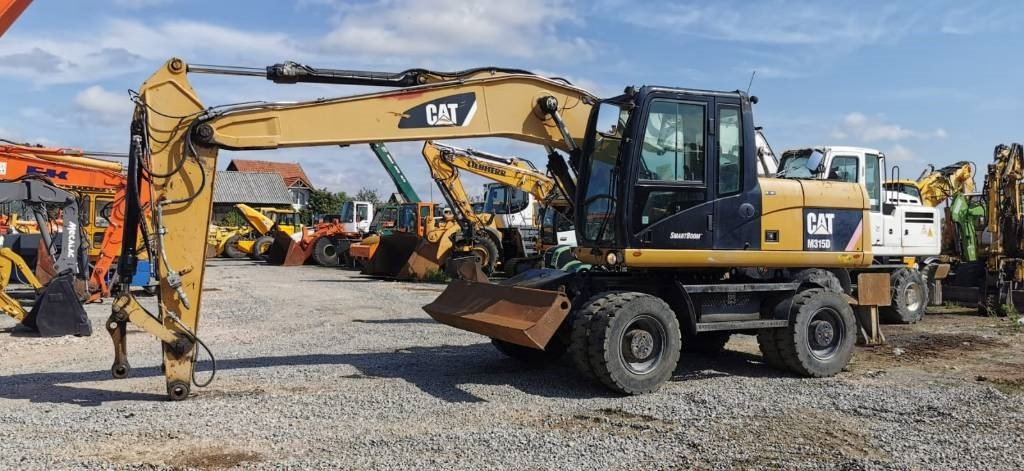 CAT M 315 D - Escavatore gommato: foto 1 CAT M 315 D - Escavatore gommato: foto 1