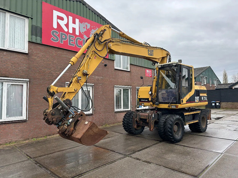 Caterpillar M315 +ROTO CE - Escavatore gommato: foto 2 Caterpillar M315 +ROTO CE - Escavatore gommato: foto 2