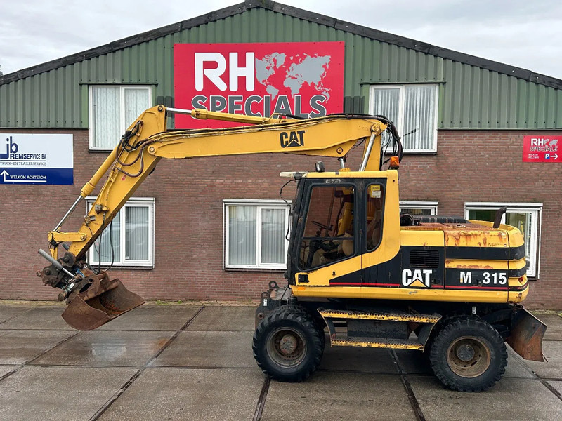 Caterpillar M315 +ROTO CE - Escavatore gommato: foto 1 Caterpillar M315 +ROTO CE - Escavatore gommato: foto 1
